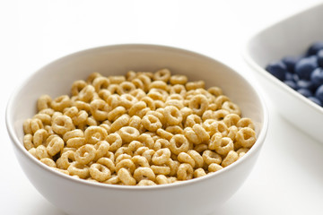 Bowl of cereal rings on white background close up