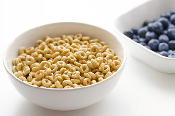 Bowl of cereal rings on white background close up