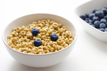 Bowl of cereal rings on white background close up