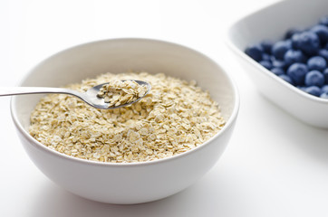 Bowl of oats on a white background