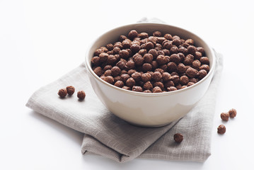 Bowl of cocoa cereals on white background
