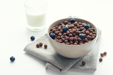 Bowl of cocoa cereals on white background