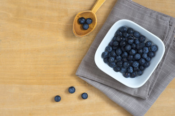 Blueberries in a bowl on a wooden table