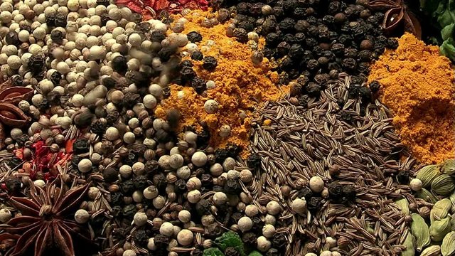 Different types of spices. Mixing white and black pepper. Macro
