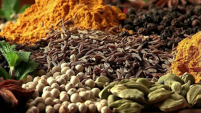 Mixing spices. Zira falls on spices. Close up