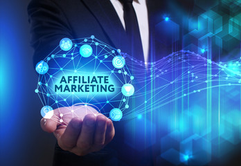 Business, Technology, Internet and network concept. Young businessman working on a virtual screen of the future and sees the inscription: Affiliate marketing