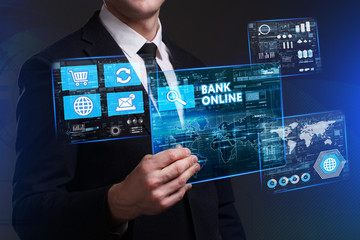 Business, Technology, Internet and network concept. Young businessman working on a virtual screen of the future and sees the inscription: Bank online