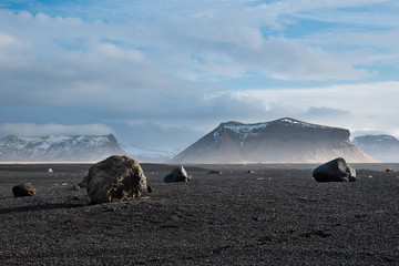 Icelandic landscape with stone and black ground