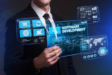 Business, Technology, Internet and network concept. Young businessman working on a virtual screen of the future and sees the inscription: Software development