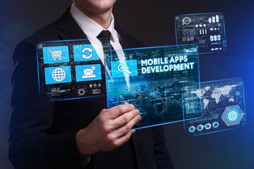 Business, Technology, Internet and network concept. Young businessman working on a virtual screen of the future and sees the inscription: Mobile apps development