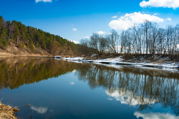 Beautiful Russian Spring Landscape With Reflection Of River, Forest, Trees And Blue Sky With Clouds.