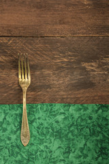 Vintage fork on wooden background with copyspace