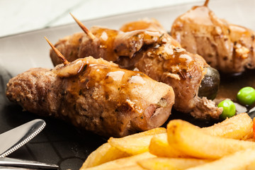 Pork rolls with french fries with vegetable