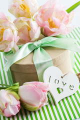 Pink purple tulips and gift box with green ribbon