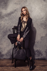 Fototapeta na wymiar Fashion Model girl full length portrait in the black suit. High fashion urban style