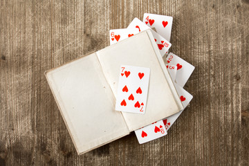 Open book and playing cards