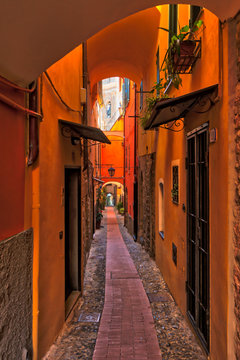 Typical narrow street, named carrugio, in a village of Liguria (Cervo), Italy.