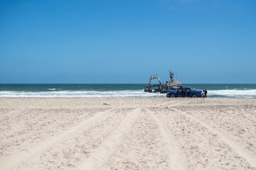 A Car and a Shipwreck Just off a Beach near Swakopmund along Namibia&rsquo;s Shipwreck Coast