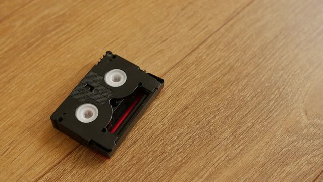 Mini DV cassettes falling on the floor, close up.