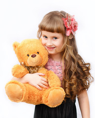 Little girl with a teddy bear on a white background
