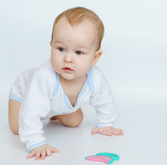 Fototapeta premium baby little child standing on all fours weared stretches to teether for teeth.