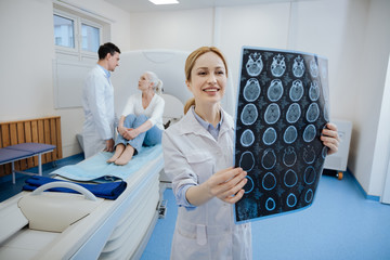 Positive happy doctor working in the CT lab