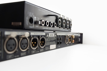 Professional sound equipment with input output connectors, back side. Selective focus