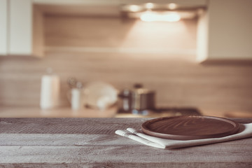 Blurred and abstract background. Empty wooden tabletop and defocused modern kitchen background for display or montage your products.