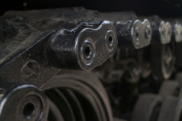ECU shallow detail of tread links on captured US Army tank on display in Vietnam