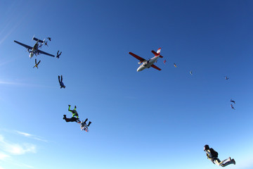 Fototapeta na wymiar Skydivers are jumping out