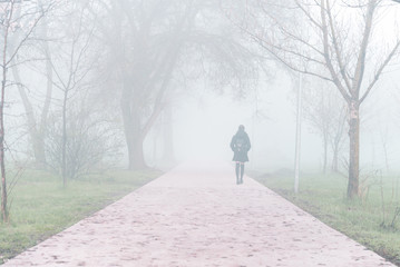 yang girl walk through park in fog