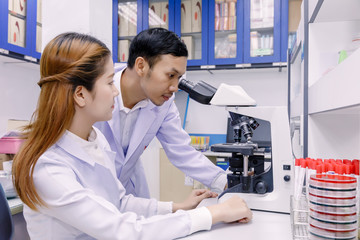 Fototapeta premium Scientist using a microscope in a laboratory.