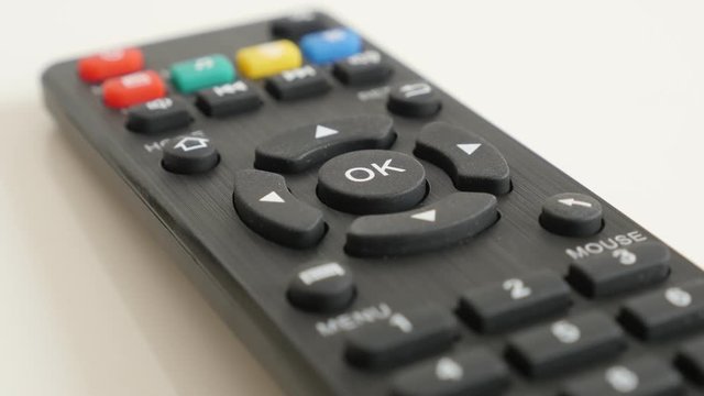 Tilting on set-top-box IR controller 4K 2160p 30fps UltraHD video - DVB-T infrared remote device on white background slow tilt 3840X2160 UHD footage 