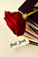 books, red rose and text Sant Jordi