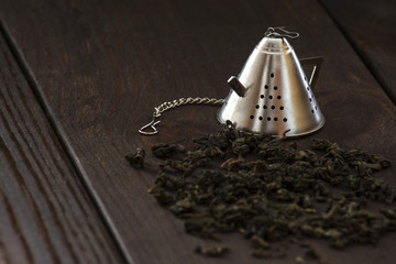 Tea strainer lying on a dark table