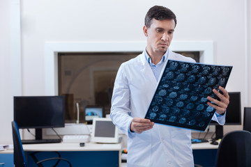 Professional male oncologist putting a diagnosis