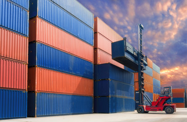 Forklift handling container in yard.