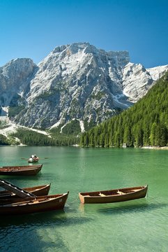 Fishing boats docked in the turquoise blue water of Lake Braies, a jewel at the foot of Croda del Becco in the Fanes- Sennes-Braies Natural Park Dolomites Trentino Alto Adige Italy Europe