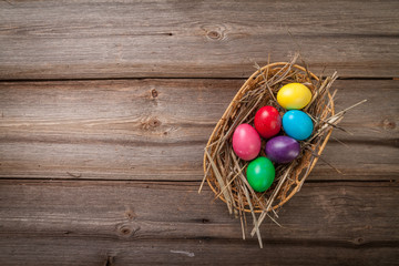Colorful Easter eggs on old wooden background