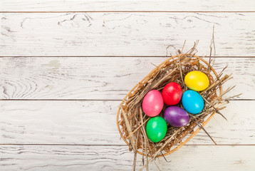 Fototapeta na wymiar Colorful Easter eggs on white wooden background