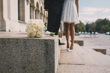 Bouquet and bride and groom in the background