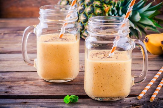 Smoothie with banana, pineapple and chia seeds in mason jars
