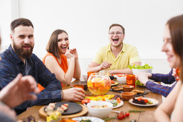 Group of happy people at festive table dinner party