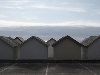 Obraz premium beach huts in a row on the beach at sunset