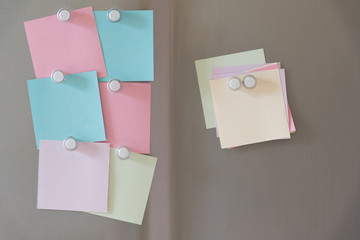 colorful magnet sticky notes on refrigerator door background