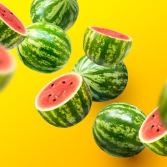 Delicious and juicy sweet watermelons sliced and whole on a summer background.