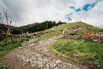 Obraz premium Stepantsminda Gergeti, Georgia. Road To Local Cemetery On The Hi