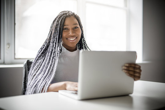 Teen At Desk In Her Office With Laptop