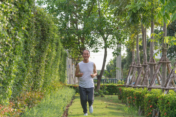 old man exercise by jogging at the park, health concept