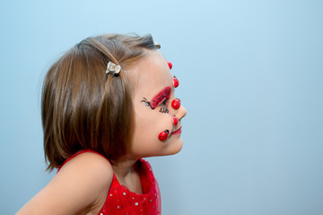 Little girl with ladybug face paint